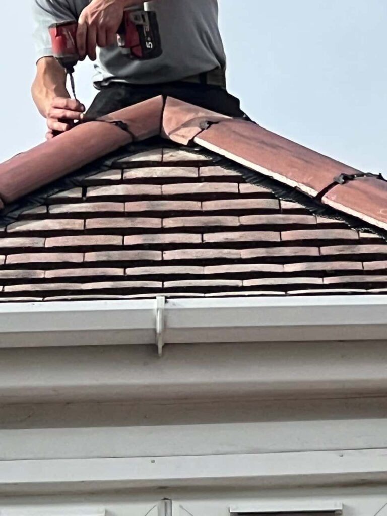 This is a photo of one of the operatives of TRP Roofing Willerby installing new ridge tiles