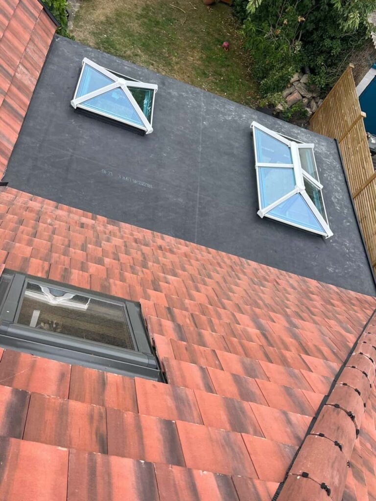 This is a photo taken from the roof ridge looking down a tiled pitched roof on to a flat roof. Works carried out by TRP Roofing Willerby